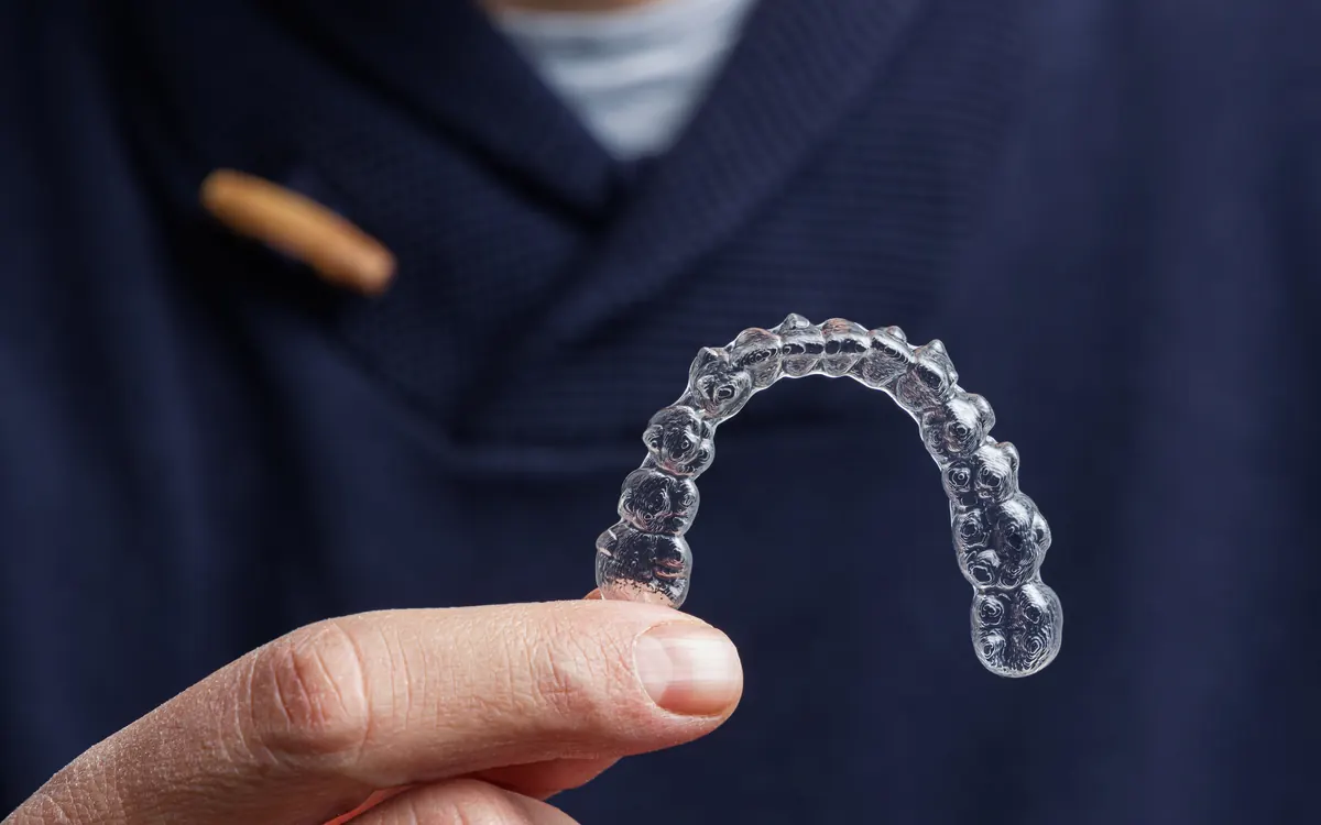 Clear aligner held up close