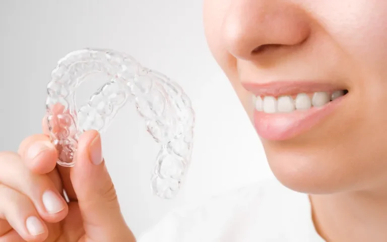 Clear aligner next to a smile